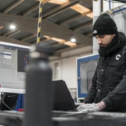 Man works on a computer in a manufacturing setting, illustrating AutoCAD on VDI with XenDesktop
