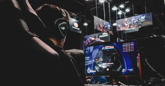 Person sitting on gaming chair while playing video game, illustrating Zynga's cloud computing advantage